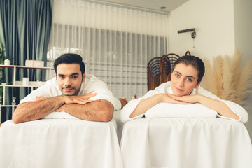 Caucasian couple customer enjoying relaxing anti-stress spa massage and pampering with beauty skin...