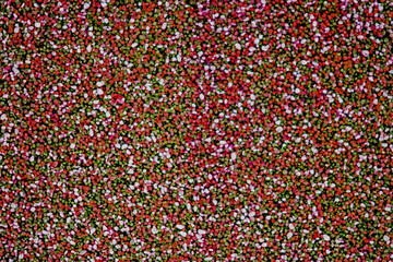 Granite-Like Rustic Texture. Old Stone Wall Background in green and red tones. Ideal as a natural stone background for vintage or earthy design projects.