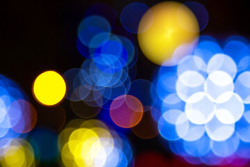 Abstract bokeh of golden and multicolored lights on a dark backdrop, evoking a magical, festive...