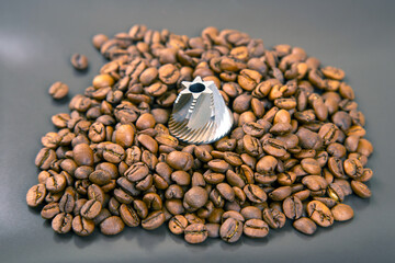Roasted coffee beans, a burr grinder, and ground coffee, showing the coffee-making process. Ideal...