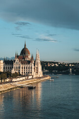 The Hungarian Parliament Building and the Danube River at sunset, Budapest, Hungary. Vertical photo
