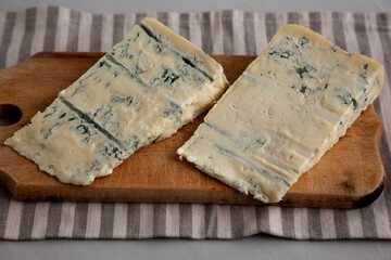 Blue cheese Gorgonzola on a Wooden Board, side view.