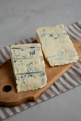 Blue cheese Gorgonzola on a Wooden Board, side view.