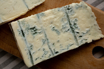 Blue cheese Gorgonzola on a Wooden Board, top view.