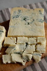 Blue cheese Gorgonzola on a Wooden Board, side view. Close-up.