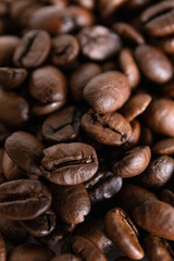 A detailed close-up image of dark roasted coffee beans, highlighting their texture.