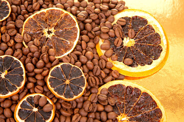 Aromatic coffee beans paired with dried orange slices on a golden surface, creating a rich,...