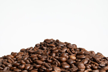 A pile of dark roasted coffee beans on a white background. There is empty space above the beans, leaving room for a logo or text.