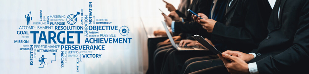 A group of business professionals engaged in a technology discussion highlighting target goals and...