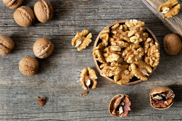 Ripe and fresh walnut kernels in bowl without shell on rustic table, healthy nut food for brain