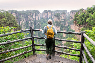 Young female tourist enjoying mountain view, the Zhangjiajie National Forest Park, Hunan Province, China