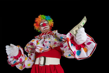 Funny clown with one dollar. Man entertainer as Joker in a suit and wig, with clown whiteface...