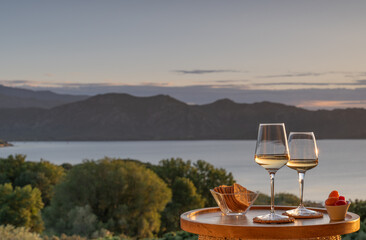 Wine and snacks with a scenic background
