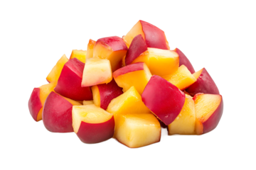 A pile of cut peaches with red skins and yellow flesh on a black background in a close up shot