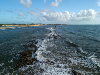  aerial view ocean waves lapping on the rocks