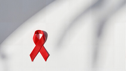 Red ribbon on a white background symbolizing World AIDS Day awareness  