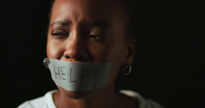 Face, help and black woman with tape in studio on dark background for gender equality or domestic violence. Portrait, silence or abuse and scared female victim with mouth covered for censored voice
