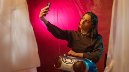 Woman Taking a Selfie With Retro Boombox and Vibrant Background