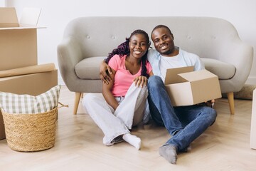 Happy Couple Unpacking Boxes in New Home After Moving
