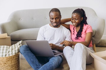 Happy african american couple planning new home using laptop © anatoliycherkas