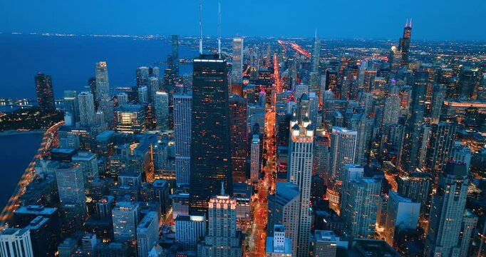 City of Chicago. Aerial view of Chicago downtown at nigh from high above. Bright yellow lights of street lighting.