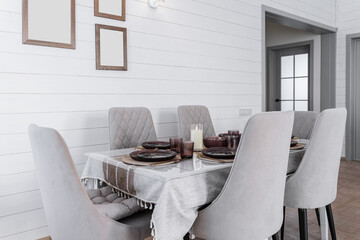 large dining table and upholstered grey chairs with backs. table is covered with linen tablecloth. dishes, glasses, candles on table. Dining room in a wooden country house. The interior of the house.