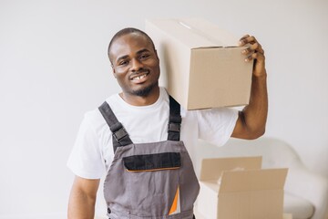 Smiling African American Mover Carrying a Cardboard Box