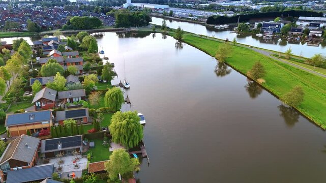 Delightful view of the village with lush greenery and canals around. Panorama of Vinkeveen, the Netherlands at dusk time.