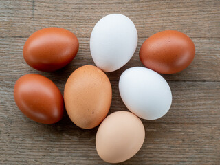 Colored eggs for Easter arranged on a wooden table for festive celebrations.