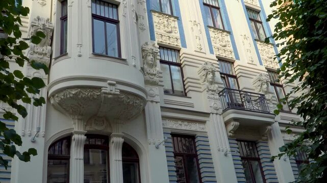One of the famous Art Nouveau architecture building facade in Riga, Latvia, Alberta street - low angle view of decorative elements and sculptures, that decorate these historical house facade.