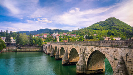 Fototapeta premium Ancient stone bridge on the Drina River. The famous historical bridge on the Drina River, built in 1571. by Mehmed Pasa Sokolovic in the city of Visegrad, Bosnia and Herzegovina.