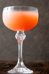 Guayaba Arabica cocktail blends guava, coffee, and rum in moody coupe glass