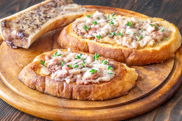 Toasted marrow sandwiches garnished with thyme served on crusty golden bread slices