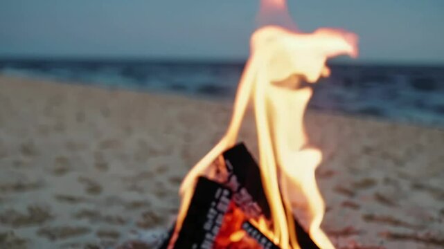 Close-up of fire on sandy beach