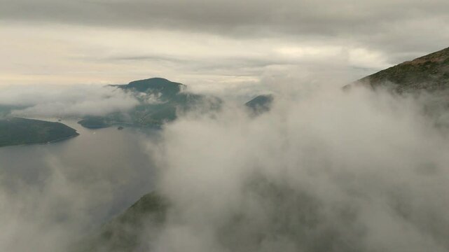 Aerial drone view of Ithaca flying through clouds foggy morning Greece Europe cinematic Vathy islands Ionian Mediterranean Sea 