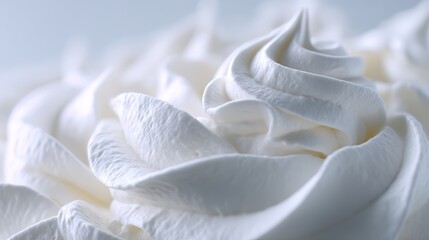 Dreamy swirls of fluffy whipped cream against soft light