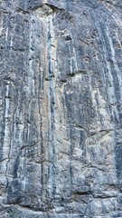Natural erosion patterns on a mountain cliff intricate streaks left by water cascading down the textured surface