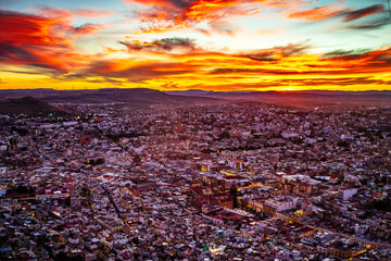 Aerial view of a city during a red sunset, view of the city of Zacatecas from La Bufa