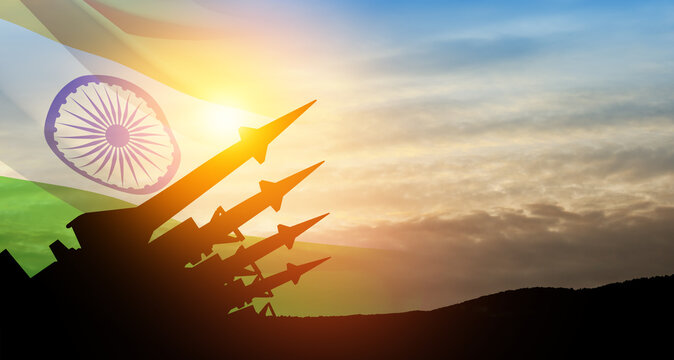 The missiles are aimed at the sky at sunset with Indian flag. Nuclear bomb, chemical weapons, missile defense.