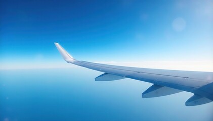 Obraz premium Airplane wing against blue sky, showcasing aerodynamic design, sky, transportation, wingspan