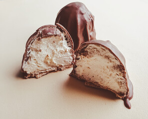 concept photo of marshmallow with broken chocolate in macro photo
