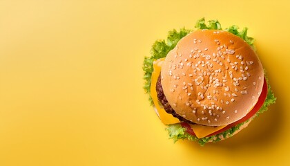 top view of hamburger fast food on yellow background with space for text