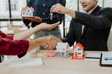 Real Estate Agent Handing Over Keys to New Homeowner