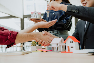 Real Estate Handshake with Model House and Keys