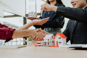 Real Estate Deal with Handshake and House Key