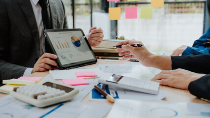 Business Team Analyzing Financial Data on Tablet