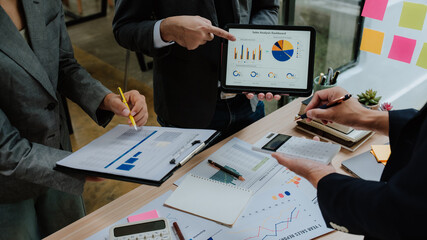 Business Team Analyzing Financial Data on Tablet