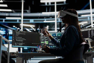 Computer scientist in data center using VR headset run artificial intelligence and machine learning processes. Server room IT expert using AI tools and virtual reality technology