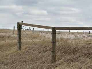 farm fencing used to enclose open fields and livestock pasture in rural Alberta, Canada.