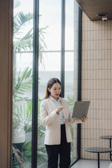 Fototapeta premium Confident Asian Businesswoman with Laptop